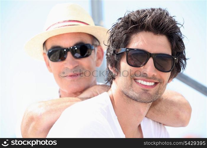 Father and son wearing sunglasses