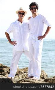 Father and son wearing white at the beach