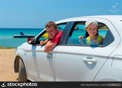 father and son went to the sea in a white car