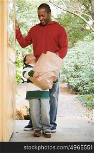 Father and son with groceries