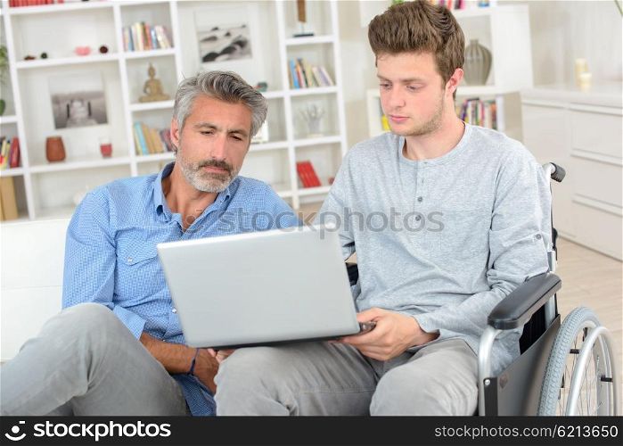 father and son with laptop