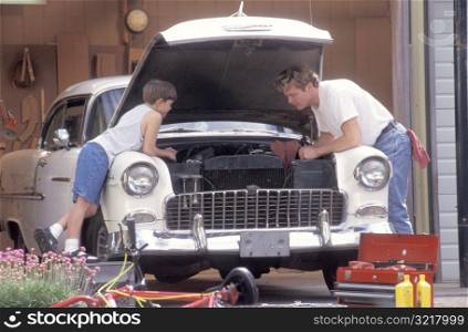 Father and Son Working on Car
