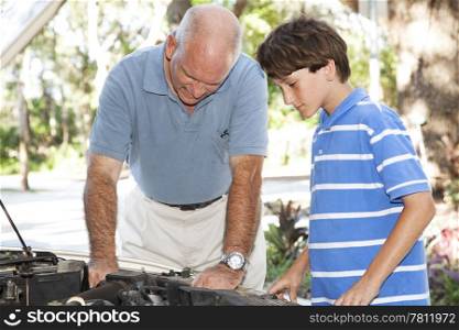Father and son working together on the car engine.