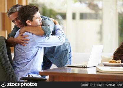 Father And Teenage Son Having A Hug