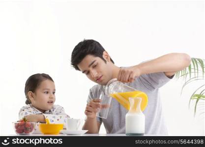 Father and young daughter having breakfast together