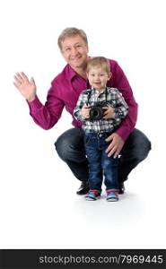 Father and young son with a camera in the studio isolate on white background.