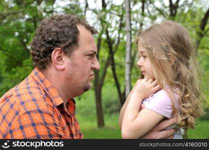 father attempting to discipline his daughter