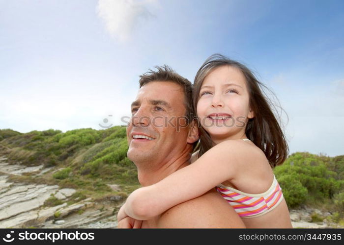 Father carrying daughter on his shoulders