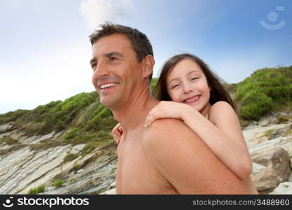 Father carrying daughter on his shoulders