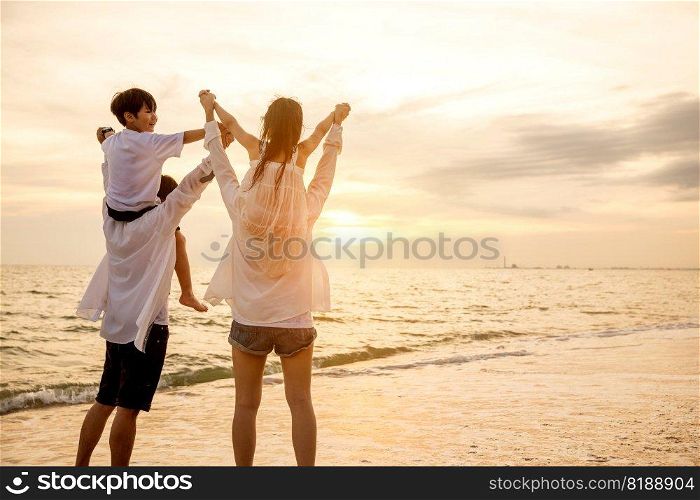 Father carrying son and Mother carrying daughter on shoulder walking summer beach, Parents carrying children on shoulders at beach on sunset, Family on holiday summer vacation, Happy family in holiday