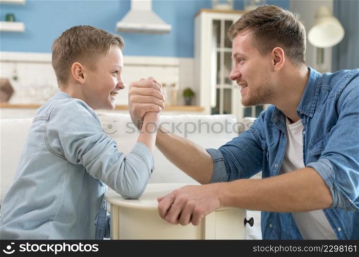 father child doing arm wrestling