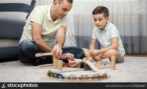father child playing with toys bedroom