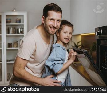 father daughter baking cookies together home