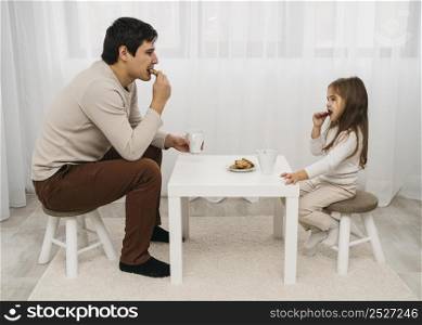 father daughter eating together home