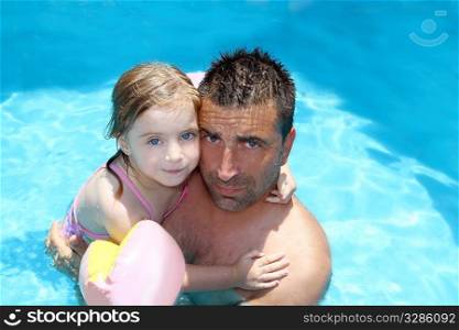 father daughter hug on blue swimming pool vacation portrait