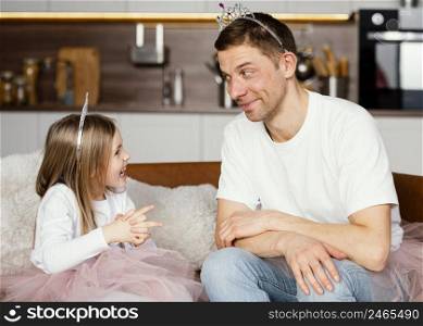 father daughter playing with tiara