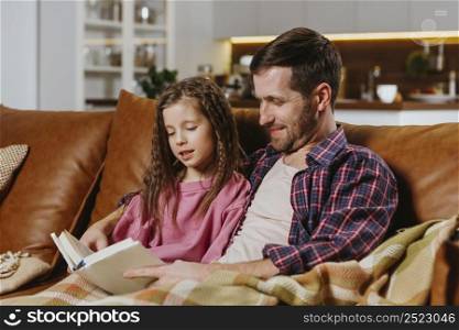 father daughter reading book home