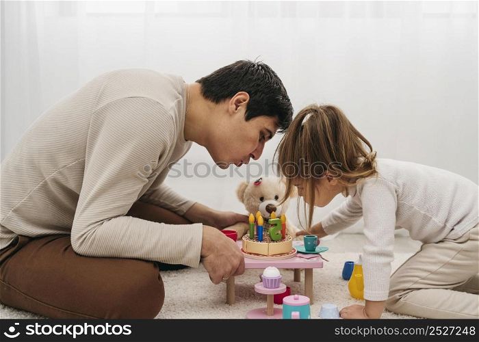 father daughter with toys home