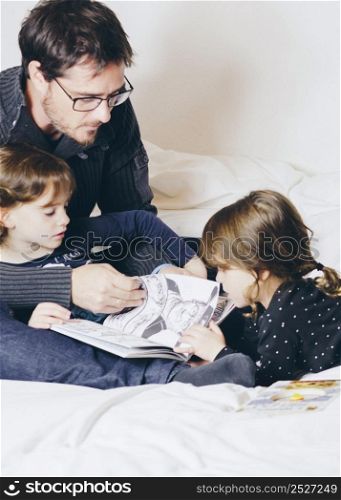 father daughters reading comic book