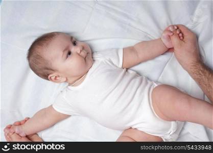 Father do everyday exercises and massaging with baby