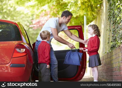 Father Driving To School With Children