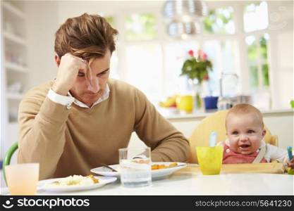 Father Feeling Depressed At Baby&#39;s Mealtime
