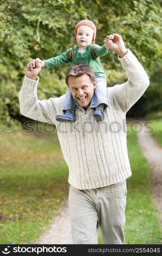 Father giving baby son piggyback