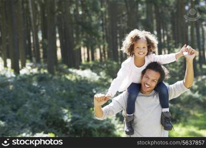 Father Giving Daughter Ride On Shoulders In Countryside