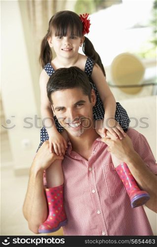 Father Giving Daughter Ride On Shoulders Indoors