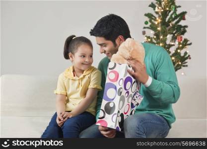 Father giving his daughter a Christmas gift