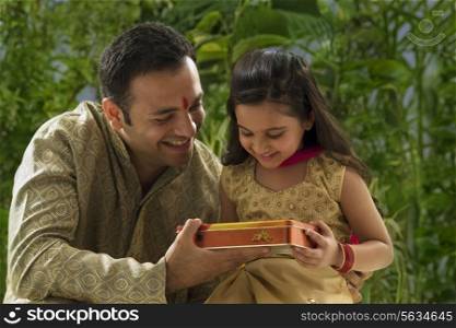 Father giving his daughter chocolates