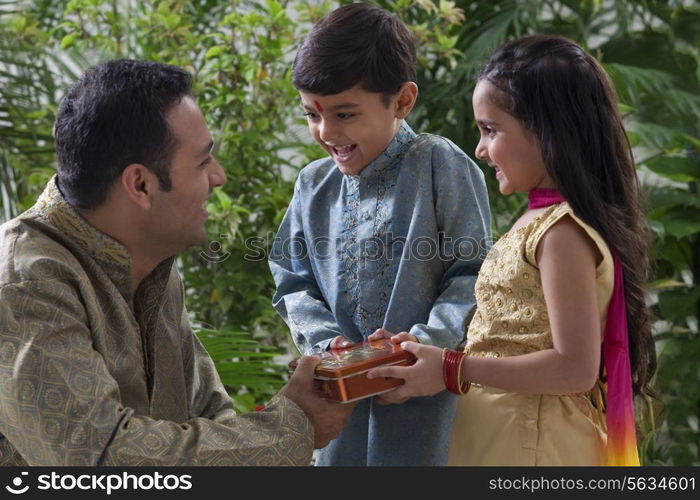 Father giving his kids chocolates