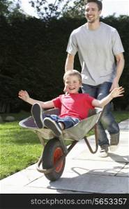 Father Giving Son Ride In Wheelbarrow