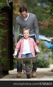 Father Giving Son Ride In Wheelbarrow