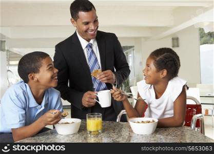 Father Having Breakfast With Children Before Work