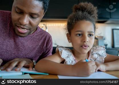 Father helping and supporting his daughter with homeschool while staying at home. New normal lifestyle concept.