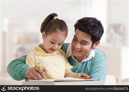 Father helping her daughter in drawing