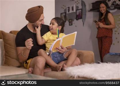 Father helping his daughter with homework while mother standing away