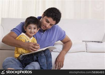 Father helping his son in drawing at home