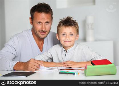 Father helping son to do homework