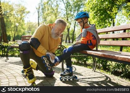 Father helping son to put on roller skates. Happy family active rest and leisure recreation time in urban park on weekend. Father helping son to put on roller skates in urban park