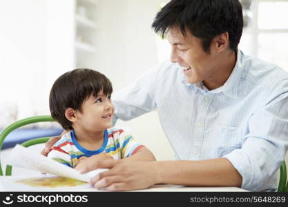 Father Helping Son With Homework