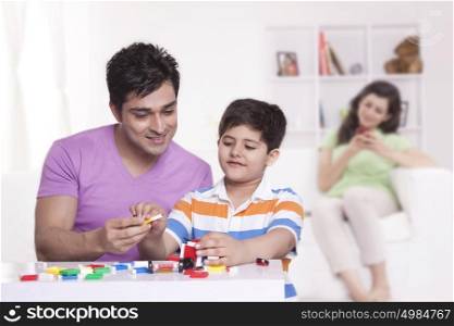 Father helping son with toys