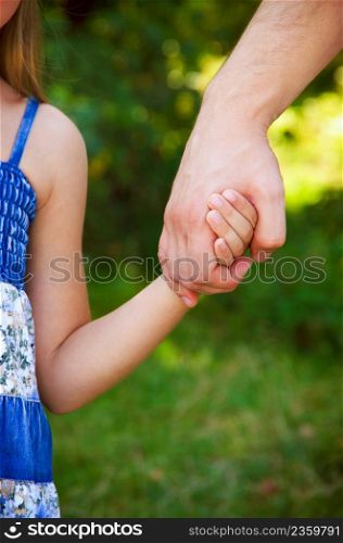 father holding daughter hand