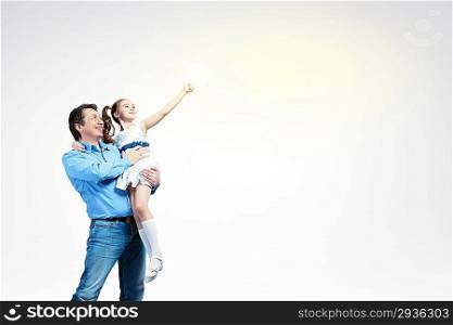 Father holding on hands daughter