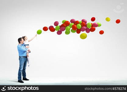 Father holding on hands daughter. Image of happy father holding on hands daughter and balloons