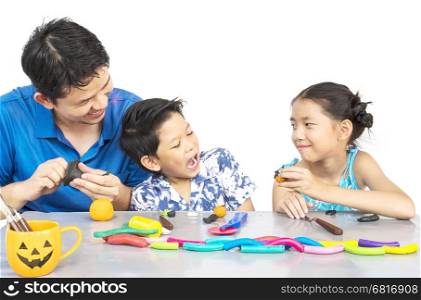 Father is playing clay toy with kid