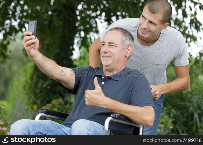 father is wheelchair with son