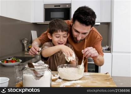 father kid cooking together