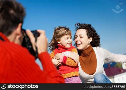 father make photos of his wife and daughter,selective focus